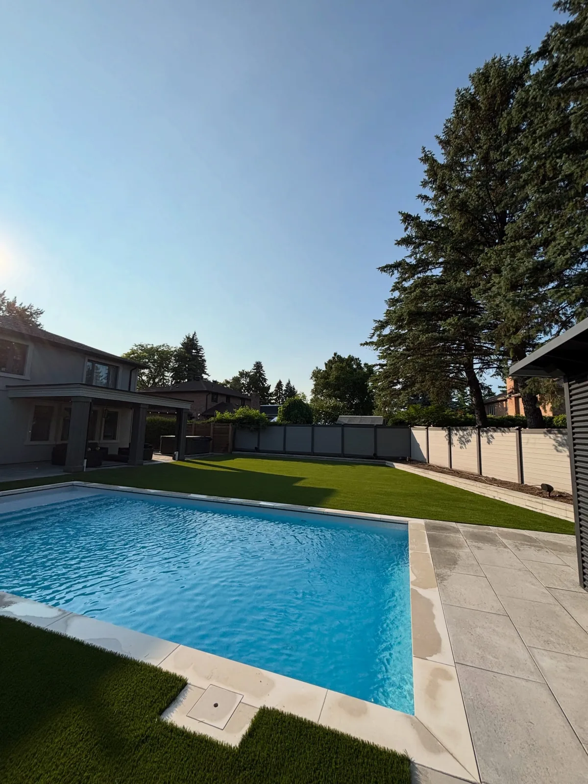 Artificial turf installed around a backyard pool in Toronto